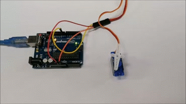 A small servo motor connected to an Arduino.
